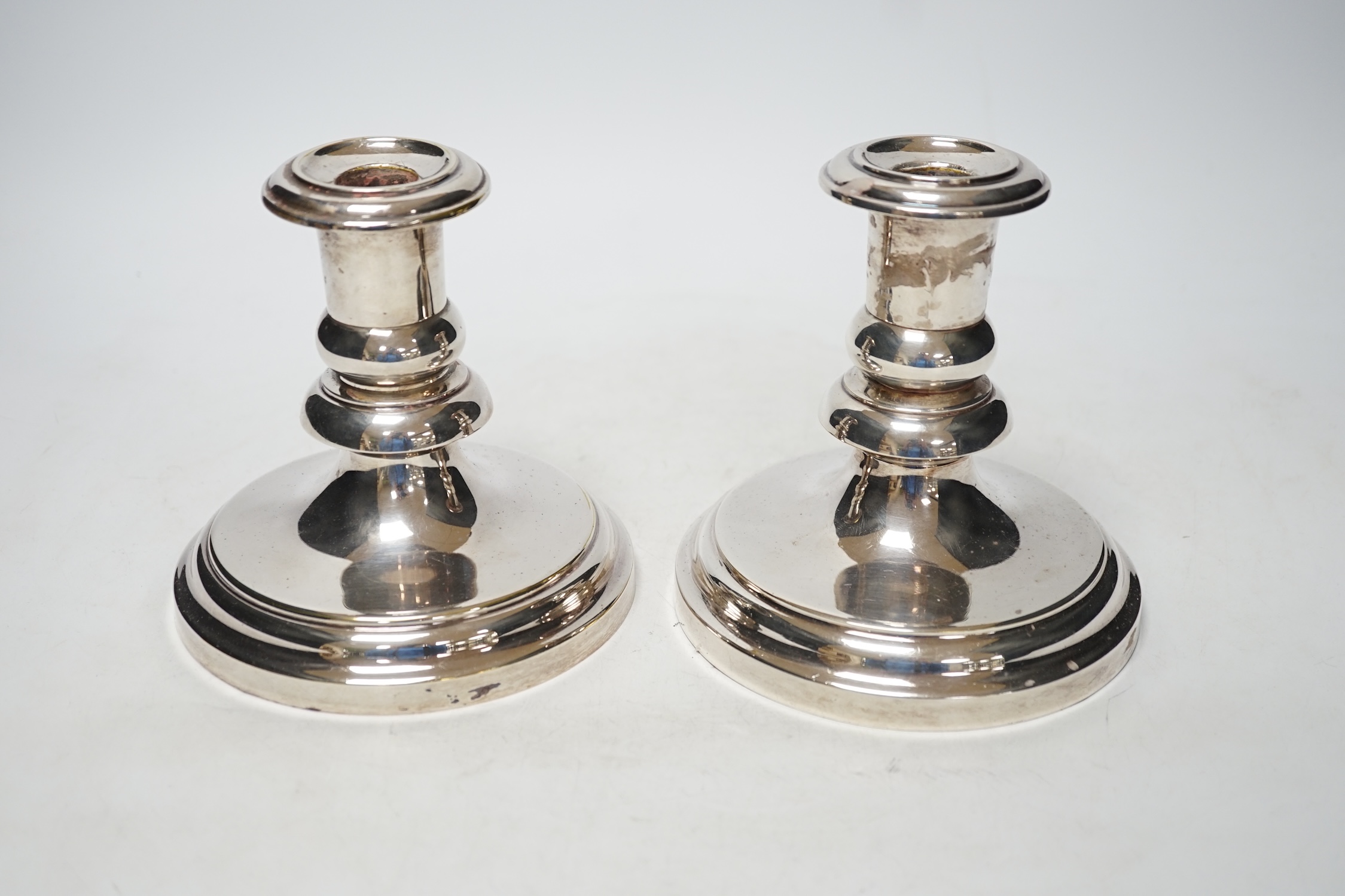 A pair of French Christofle silver plated dwarf candlesticks, 14cm